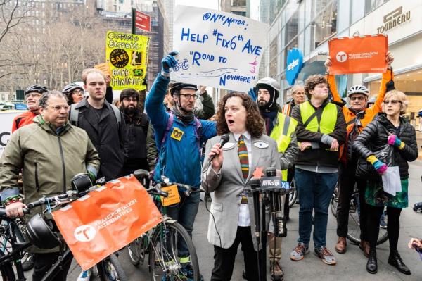 activists wearing yellow safety vests hold a rally