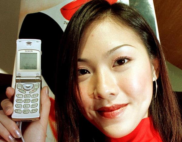 Young woman with a flip phone