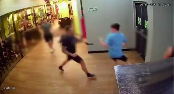 The enraged cop attacks one of the woman's friends for trying to intervene.